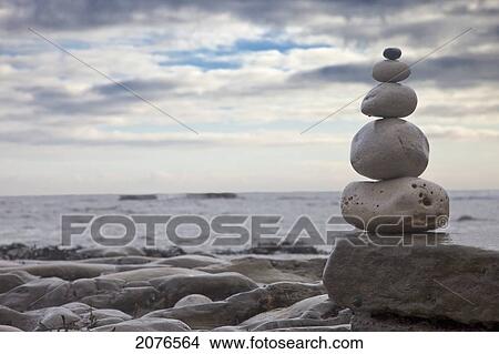 Picture - Pile of rocks balanced on a boulder at the water's edge; south shields tyne and wear england. Fotosearch
