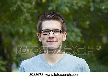 Stock Image - Portait Of A Young Man In A Park; Edmonton Alberta Canada. Fotosearch