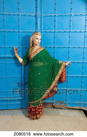 Portrait of a blond woman wearing a sari in front of blue doors; ludhiana punjab india View Large Photo Image Stock Photo - Portrait of a blond woman wearing a sari in front of blue doors; ludhiana punjab india. Fotosearch
