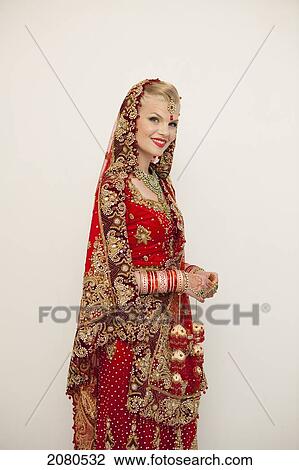 Portrait of a bride with blond hair wearing a red and gold sari; ludhiana punjab india View Large Photo Image Stock Image - Portrait of a bride with blond hair wearing a red and gold sari; ludhiana punjab india. Fotosearch