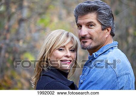 Stock Image - Portrait Of A Couple In A Park In Autumn; St. Albert Alberta Canada. Fotosearch