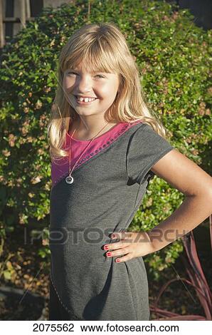 Stock Image - Portrait Of A Girl Wearing A Dress Outside; Moraga California United States Of America. Fotosearch