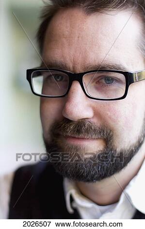 Portrait Of A Man With A Beard And Glasses; Cambridge England View Large Photo Image Stock Photo - Portrait Of A Man With A Beard And Glasses; Cambridge England. Fotosearch