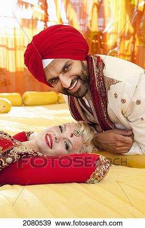 Portrait of a mixed race couple on their wedding day in traditional indian garments for a wedding; ludhiana punjab india View Large Photo Image Stock Photo - Portrait of a mixed race couple on their wedding day in traditional indian garments for a wedding; ludhiana punjab india. Fotosearch