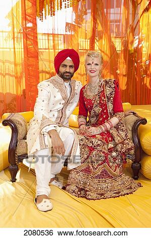 Portrait of a mixed race couple on their wedding day in traditional indian garments for a wedding; ludhiana punjab india View Large Photo Image Stock Photograph - Portrait of a mixed race couple on their wedding day in traditional indian garments for a wedding; ludhiana punjab india. Fotosearch