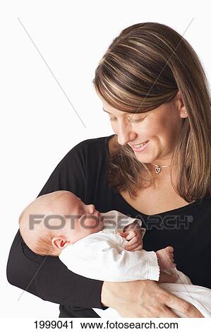 Stock Image - Portrait Of A Mother With A Newborn Baby; Dundas Minnesota United States Of America. Fotosearch
