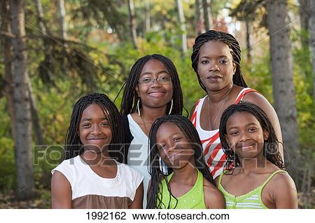 Stock Image - Portrait Of A Mother With Four Daughters In A Park; Edmonton Alberta Canada. Fotosearch