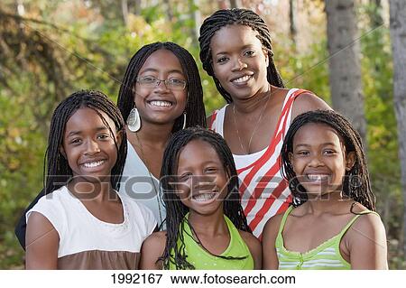 Stock Photo - Portrait Of A Mother With Four Daughters In A Park; Edmonton Alberta Canada. Fotosearch