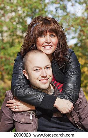 Stock Photo - Portrait Of A Newlywed Couple In A Park; Edmonton Alberta Canada. Fotosearch