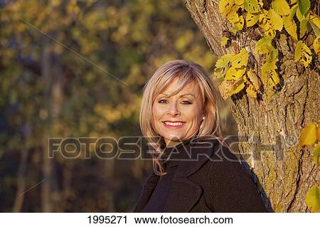 Stock Image - Portrait Of A Woman In A Park In Autumn; St. Albert Alberta Canada. Fotosearch