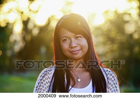 Portrait Of A Young Filipino Woman In A Park; Edmonton Alberta Canada View Large Photo Image Stock Photo - Portrait Of A Young Filipino Woman In A Park; Edmonton Alberta Canada. Fotosearch