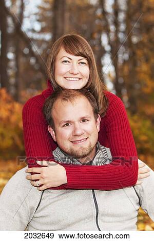 Stock Photo - Portrait Of A Young Married Couple In A Park In Autumn; Edmonton Alberta Canada. Fotosearch