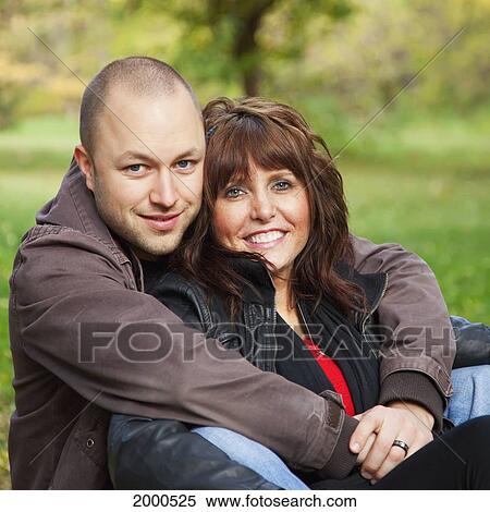Stock Photography - Portrait Of A Young Married Couple In A Park; Edmonton Alberta Canada. Fotosearch