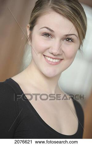 Portrait of a young woman in a black scoop neck shirt; troutdale oregon united states of america View Large Photo Image Stock Image - Portrait of a young woman in a black scoop neck shirt; troutdale oregon united states of america. Fotosearch