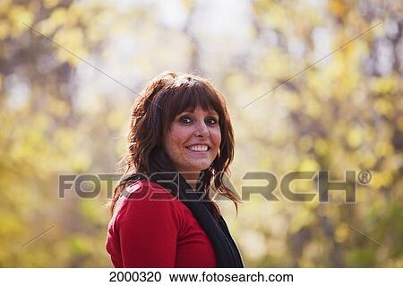 Portrait Of A Young Woman In A Park In Autumn; Edmonton Alberta Canada View Large Photo Image Stock Image - Portrait Of A Young Woman In A Park In Autumn; Edmonton Alberta Canada. Fotosearch