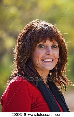 Stock Photo - Portrait Of A Young Woman In A Park In Autumn; Edmonton Alberta Canada. Fotosearch