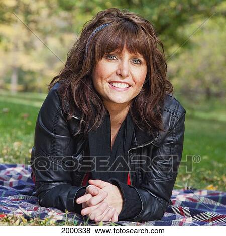 Stock Photo - Portrait Of A Young Woman In A Park; Edmonton Alberta Canada. Fotosearch