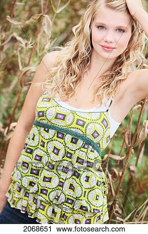 Portrait Of A Young Woman With Hand In Hair And A Patterned Top; Troutdale Oregon United States Of America View Large Photo Image Stock Image - Portrait Of A Young Woman With Hand In Hair And A Patterned Top; Troutdale Oregon United States Of America. Fotosearch