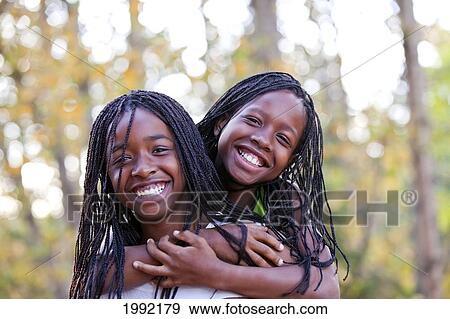Stock Photo - Portrait Of Sisters; Edmonton Alberta Canada. Fotosearch