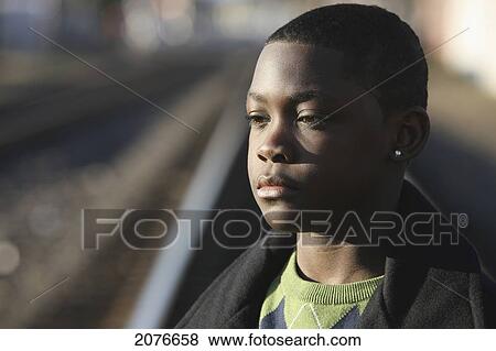 Portrait of teenage boy by train tracks; portland oregon united states of america View Large Photo Image Stock Photo - Portrait of teenage boy by train tracks; portland oregon united states of america. Fotosearch