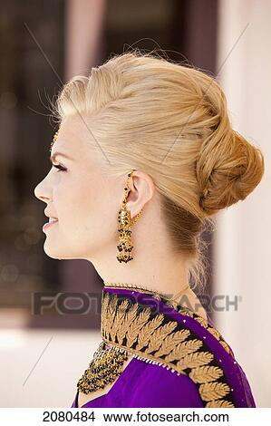 Profile of a woman with blond hair wearing a purple sari and ornate jewelry; ludhiana punjab india View Large Photo Image Picture - Profile of a woman with blond hair wearing a purple sari and ornate jewelry; ludhiana punjab india. Fotosearch