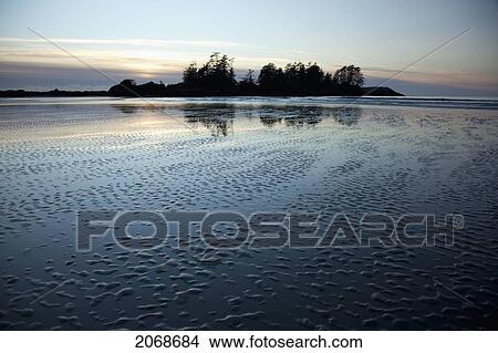Picture - Reflections On Chesterman's Beach Of Frank Island Near Tofino; British Columbia Canada. Fotosearch