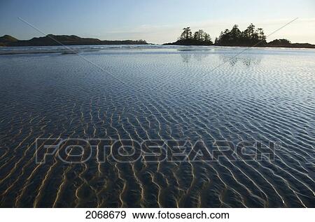 Stock Photo - Ripples Form In The Sand At Chesterman's Beach And Frank Island Near Tofino; British Columbia Canada. Fotosearch