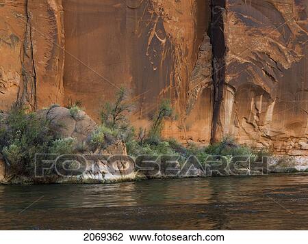 Rock Cliff Along The Shoreline Of The Colorado River; Arizona United States Of America View Large Photo Image Stock Image - Rock Cliff Along The Shoreline Of The Colorado River; Arizona United States Of America. Fotosearch
