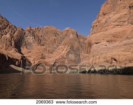 Stock Image - Rock Cliffs Along The Shoreline Of The Colorado River; Arizona United States Of America. Fotosearch