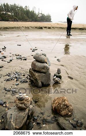 Rock Formations On A Beach With A Woman Looking At The Sand In The Background; Seattle Washington United States Of America View Large Photo Image Stock Photography - Rock Formations On A Beach With A Woman Looking At The Sand In The Background; Seattle Washington United States Of America. Fotosearch