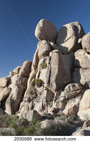 Rounded Rock Cliff In Desert With Shrubs And Deep Blue Sky; Palm Springs California United States Of America View Large Photo Image Stock Photo - Rounded Rock Cliff In Desert With Shrubs And Deep Blue Sky; Palm Springs California United States Of America. Fotosearch