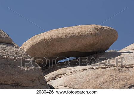 Stock Photograph - Rounded Rock On Top Of Desert Rock With Blue Sky; Palm Springs California United States Of America. Fotosearch
