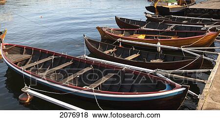 Stock Photo - Rowboats moored by a dock at skeppsholmen; stockholm sweden. Fotosearch