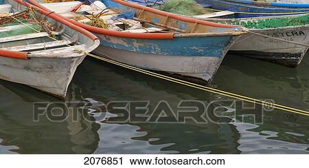 Rowboats with peeling paint tied to the shore with rope; sayulita mexico View Large Photo Image Stock Image - Rowboats with peeling paint tied to the shore with rope; sayulita mexico. Fotosearch