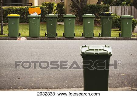 Stock Photo - Rubbish Bins On A Curb In A Residential Area; Gold Coast Queensland Australia. Fotosearch