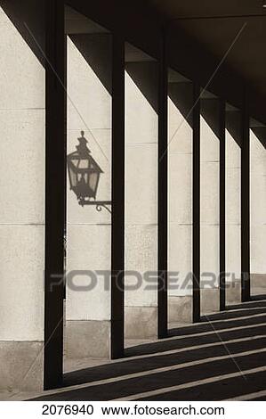 Stock Image - Shadows cast by sunlight shining on pillars and a lantern; stockholm sweden. Fotosearch