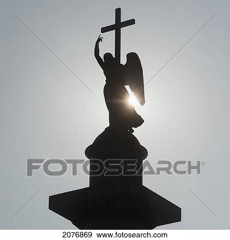 Silhouette of an angel statue and cross; st. petersburg russia View Large Photo Image Stock Photo - Silhouette of an angel statue and cross; st. petersburg russia. Fotosearch