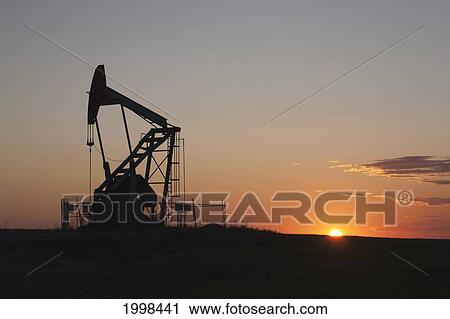 Silhouette Of Pumpjack With The Orange Glow Of The Sun Rising On The Horizon; Longview Alberta Canada View Large Photo Image Stock Image - Silhouette Of Pumpjack With The Orange Glow Of The Sun Rising On The Horizon; Longview Alberta Canada. Fotosearch