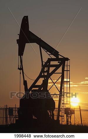 Silhouette Of Pumpjack With The Orange Glow Of The Sun Rising; Longview Alberta Canada View Large Photo Image Stock Photo - Silhouette Of Pumpjack With The Orange Glow Of The Sun Rising; Longview Alberta Canada. Fotosearch