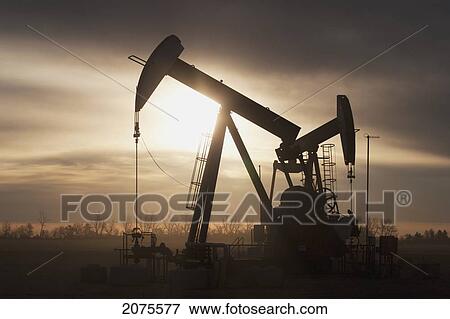 Silhouette Of Two Pump Jacks At Sunrise With Clouds; Alberta Canada View Large Photo Image Stock Photo - Silhouette Of Two Pump Jacks At Sunrise With Clouds; Alberta Canada. Fotosearch