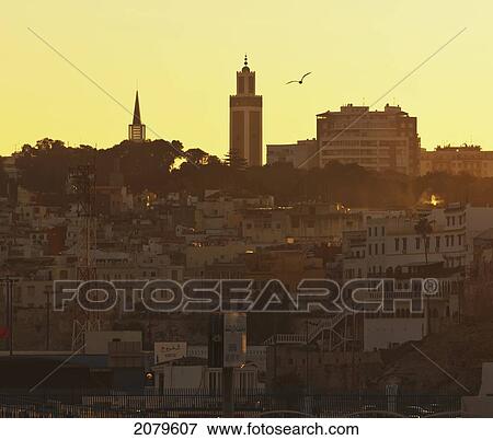 Skyline at dusk with the minaret of mohammed v mosque centre and spire of roman catholic church to left; tangiers morocco View Large Photo Image Stock Photo - Skyline at dusk with the minaret of mohammed v mosque centre and spire of roman catholic church to left; tangiers morocco. Fotosearch