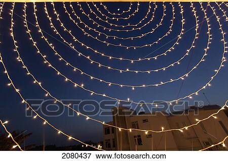 Stock Photo - Small white lights strung in a circular pattern against a night sky; ludhiana punjab india. Fotosearch