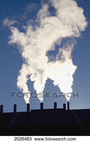 Smoke Arising From Stacks Against A Blue Sky; Calgary Alberta Canada View Large Photo Image Stock Image - Smoke Arising From Stacks Against A Blue Sky; Calgary Alberta Canada. Fotosearch