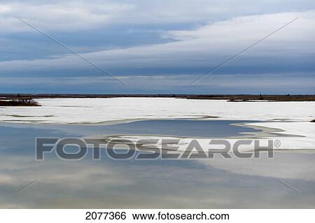 Stock Photograph - Snow and ice along the shores of hudson bay with a flat landscape; churchill manitoba canada. Fotosearch