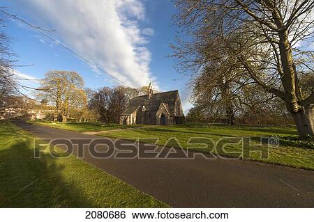 Stock Photograph - St. mary the virgin church along a road; etal northumberland england. Fotosearch