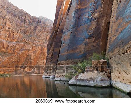 Steep Rock Cliffs Along The Shoreline Of Colorado River; Arizona United States Of America View Large Photo Image Stock Photo - Steep Rock Cliffs Along The Shoreline Of Colorado River; Arizona United States Of America. Fotosearch
