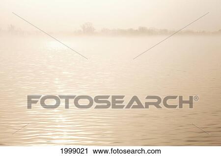 Sunlight Reflecting On The Water At Sunrise Through The Mist; Spicer Minnesota United States Of America View Large Photo Image Stock Image - Sunlight Reflecting On The Water At Sunrise Through The Mist; Spicer Minnesota United States Of America. Fotosearch