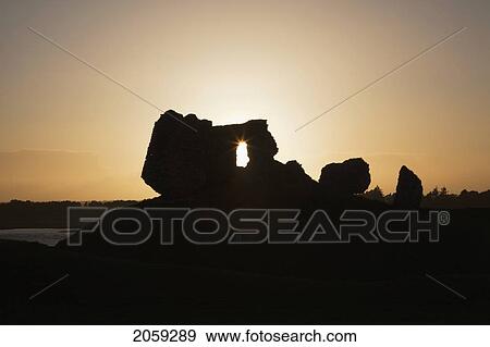 Sunlight Shining Through A Hole In A Rock Formation At Sunset; Clonmacnoise County Offaly Ireland View Large Photo Image Stock Photo - Sunlight Shining Through A Hole In A Rock Formation At Sunset; Clonmacnoise County Offaly Ireland. Fotosearch
