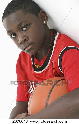 Teenage boy in red jersey holding basketball; portland oregon united states of america View Large Photo Image Stock Image - Teenage boy in red jersey holding basketball; portland oregon united states of america. Fotosearch
