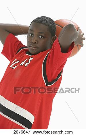 Teenage boy in red jersey holding basketball behind head; portland oregon united states of america View Large Photo Image Stock Photo - Teenage boy in red jersey holding basketball behind head; portland oregon united states of america. Fotosearch